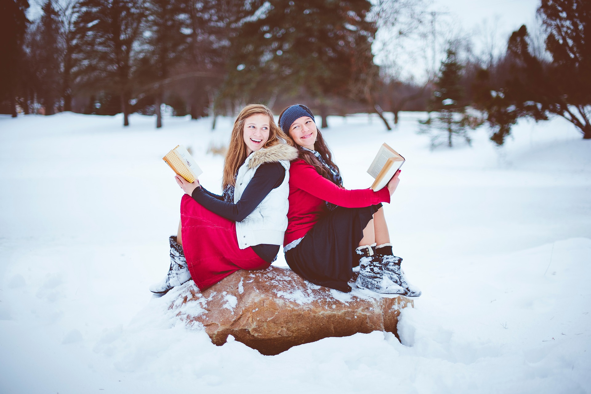 girls in snow reading